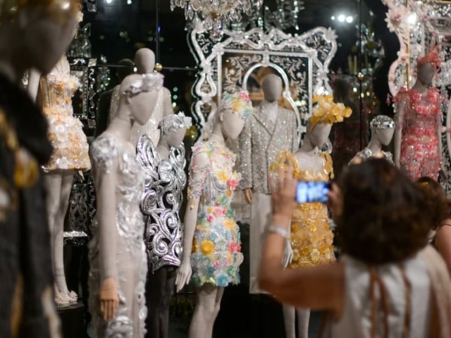 visitors look at the creations displayed at the exhibition from the heart to the hands dolce gabbana at the palazzo reale in milan italy july 23 2024 photo reuters